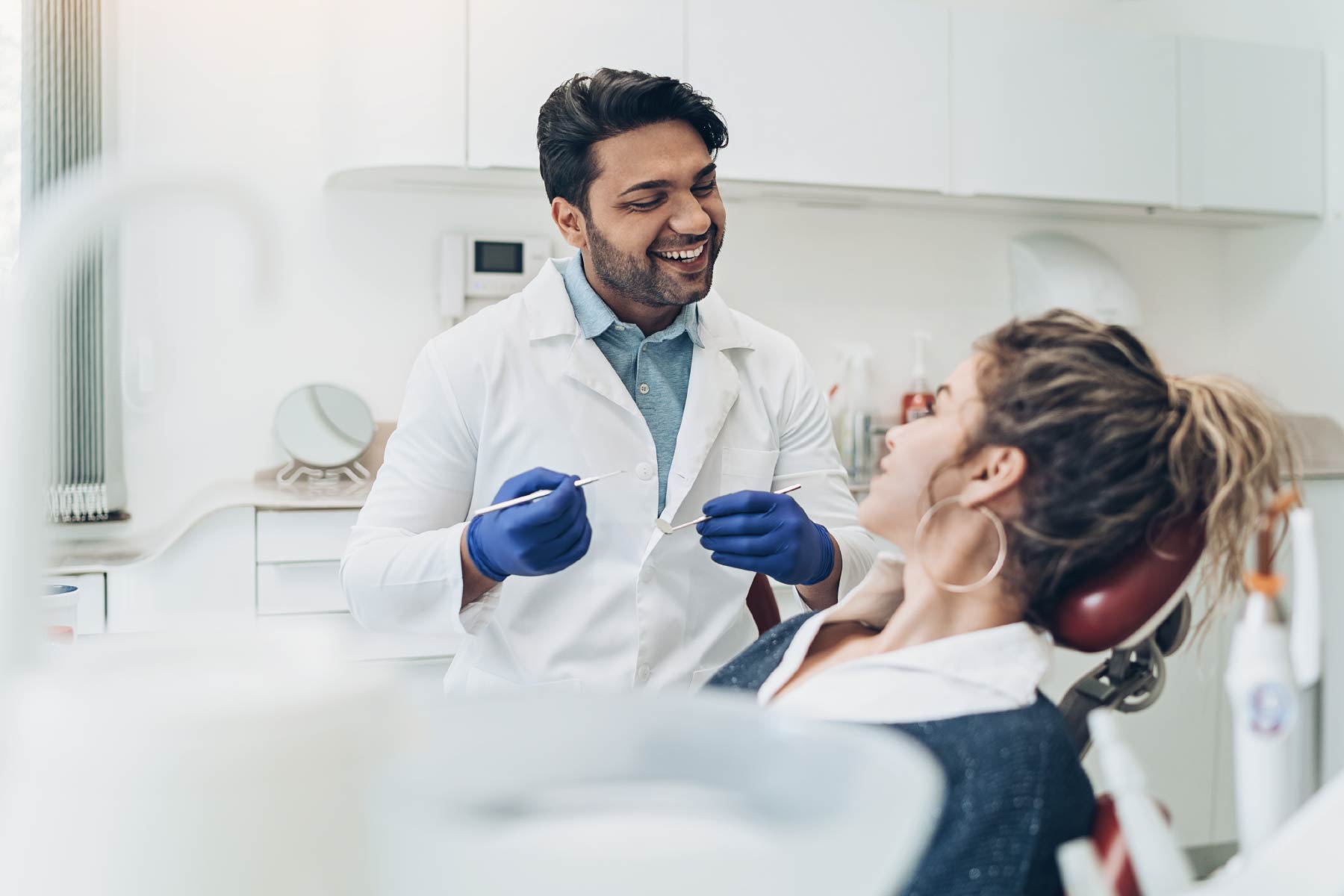 Dentist talking to patient during check-up